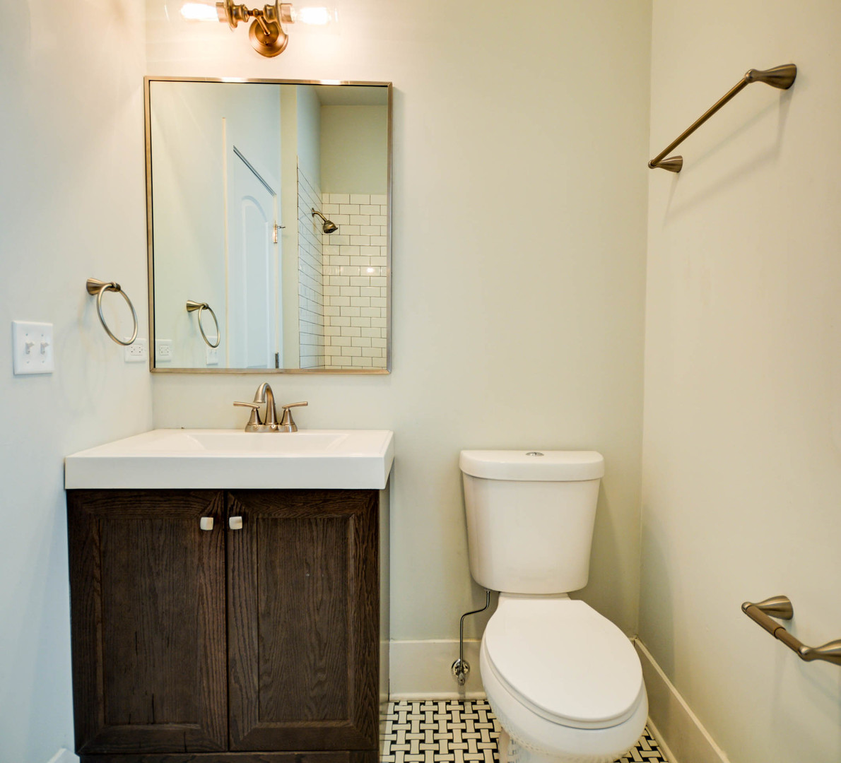 1724 West 21st Street, Unit 3F Chicago, IL 60608 - Photo 10 of 13 a bathroom with a sink a toilet and a mirror