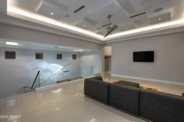 a living room with furniture and a chandelier