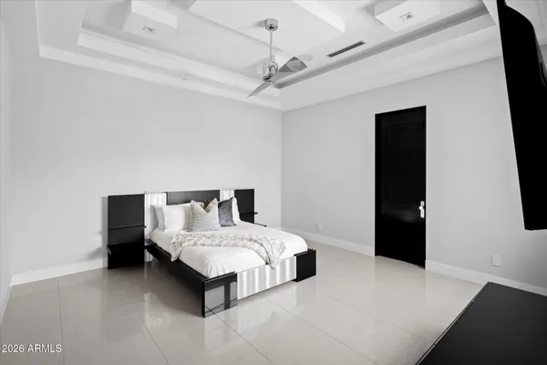 a bedroom with a large bed and a flat tv screen on a dresser