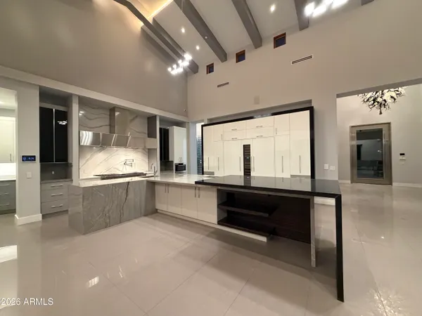 a large kitchen with kitchen island a sink stainless steel appliances and cabinets