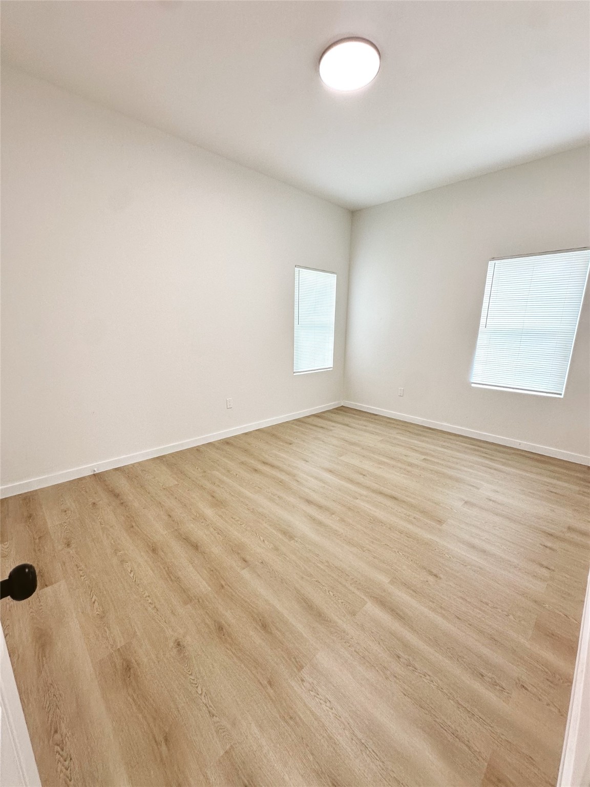 9709 Cargill Street Houston, TX 77029 - Photo 15 of 22 an empty room with wooden floor and windows