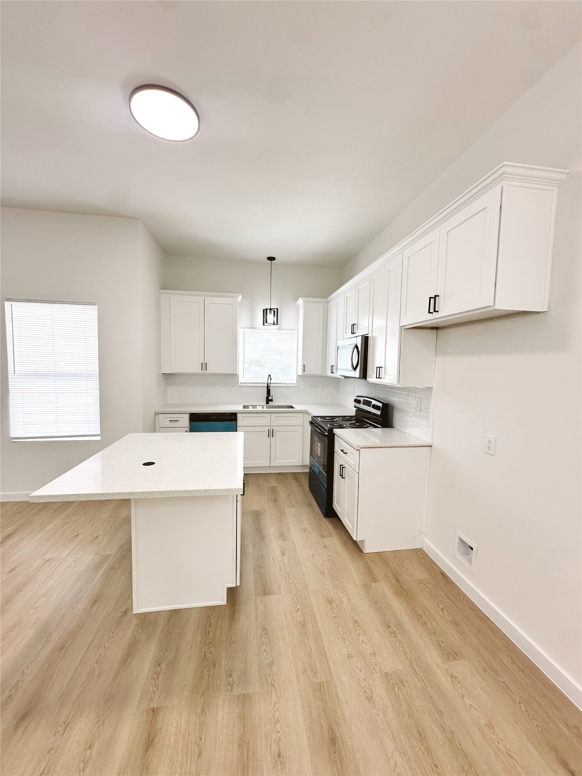9709 Cargill Street Houston, TX 77029 - Photo 6 of 22 a kitchen with white cabinets and white appliances