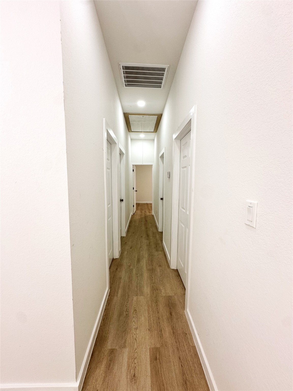 9709 Cargill Street Houston, TX 77029 - Photo 8 of 22 a view of a hallway with wooden floor