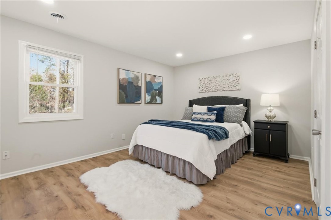 5712 Retriever Road Richmond, VA 23237 - Photo 30 of 40 Bedroom featuring light wood finished floors and r
