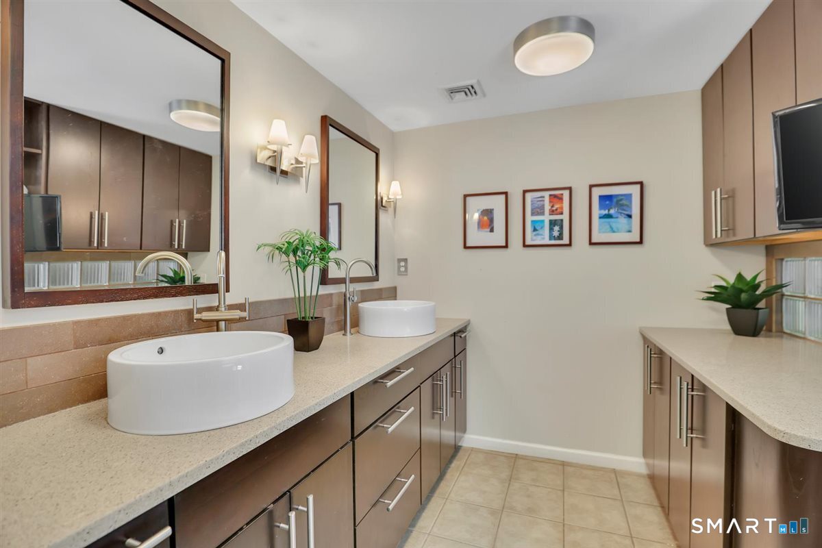 122 Ridgeview Circle Guilford, CT 06437 - Photo 12 of 40 Updated master bath with tiled floor, dual vessel sink vanity, custom built-ins, walk-in shower and jetted stream bath.