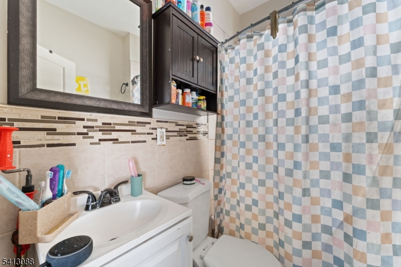 907 Flora Street Elizabeth, NJ 07201 - Photo 12 of 24 a bathroom with a sink and a toilet