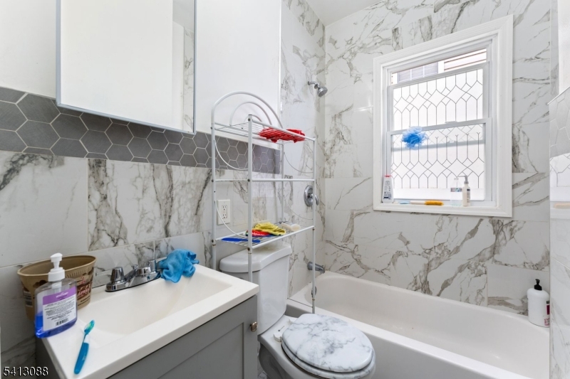 907 Flora Street Elizabeth, NJ 07201 - Photo 16 of 24 a bathroom with a sink toilet and tub