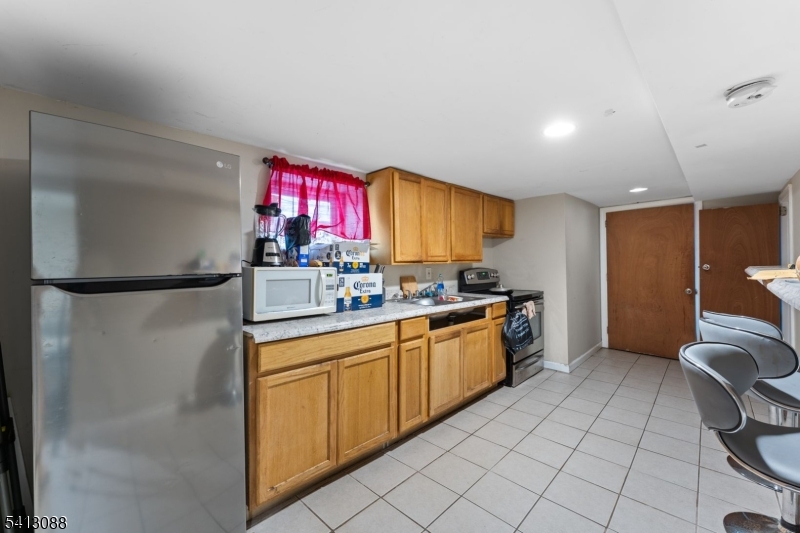 907 Flora Street Elizabeth, NJ 07201 - Photo 20 of 24 a kitchen with a sink cabinets and wooden floor