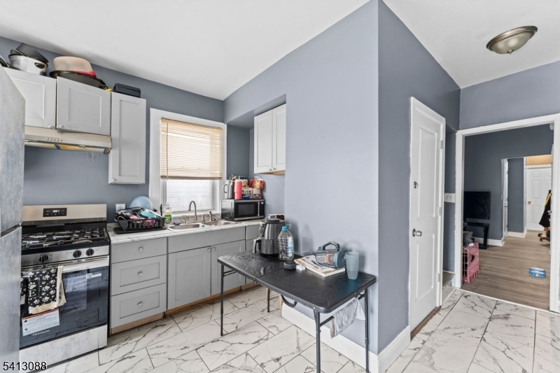 907 Flora Street Elizabeth, NJ 07201 - Photo 6 of 24 a kitchen with a sink cabinets and window