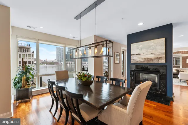 a view of a hallway with a livingroom and a bathroom with sink