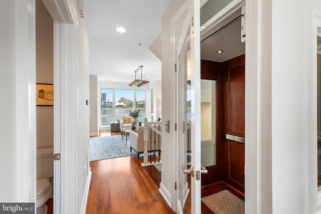 a living room with furniture a rug and a flat screen tv