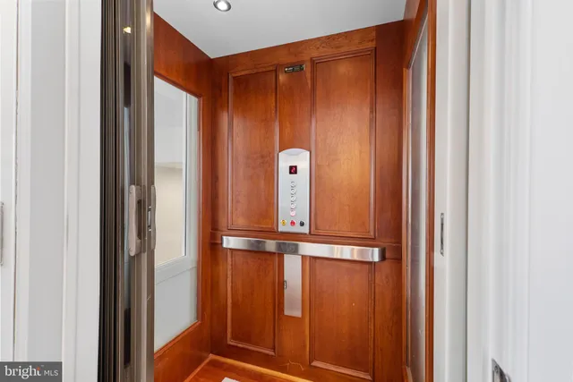 a living room with furniture a flat screen tv and a table