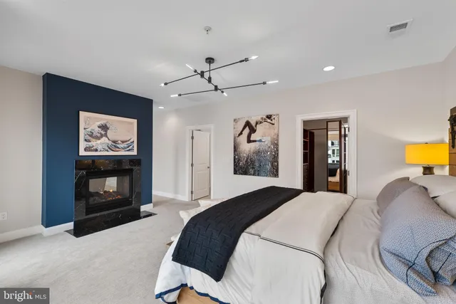 a bedroom with two beds and painting on the wall