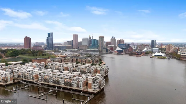 a front view of a building with lot of cars