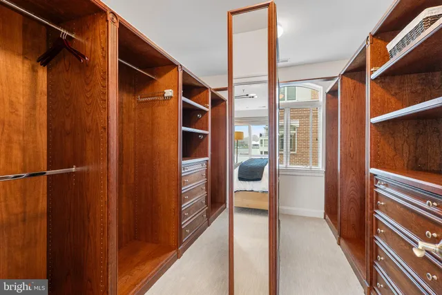 a view of a hallway with wooden floor and a living room