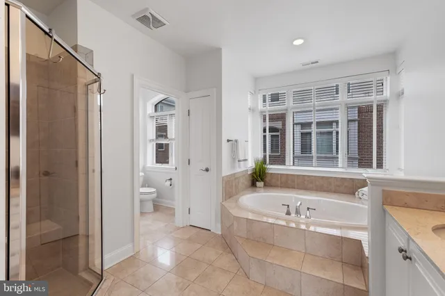 a bedroom with a large bed and a large window