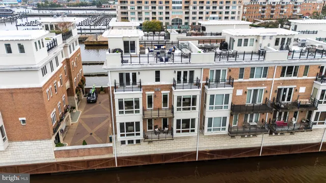 a living room with furniture kitchen view and a large window