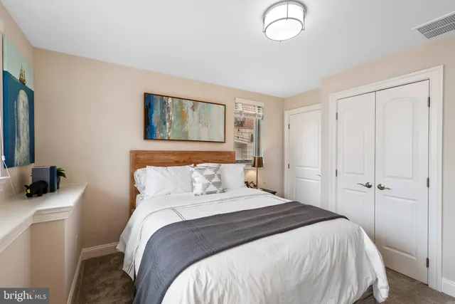 a view of a kitchen with kitchen island stainless steel appliances wooden floor and chandelier