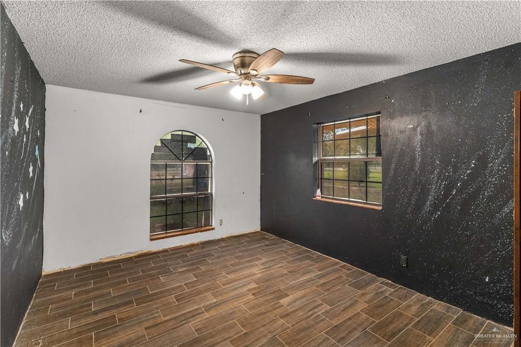 7654 East Alberta Road Edinburg, TX 78542 - Photo 11 of 33 a view of a livingroom with a ceiling fan and window