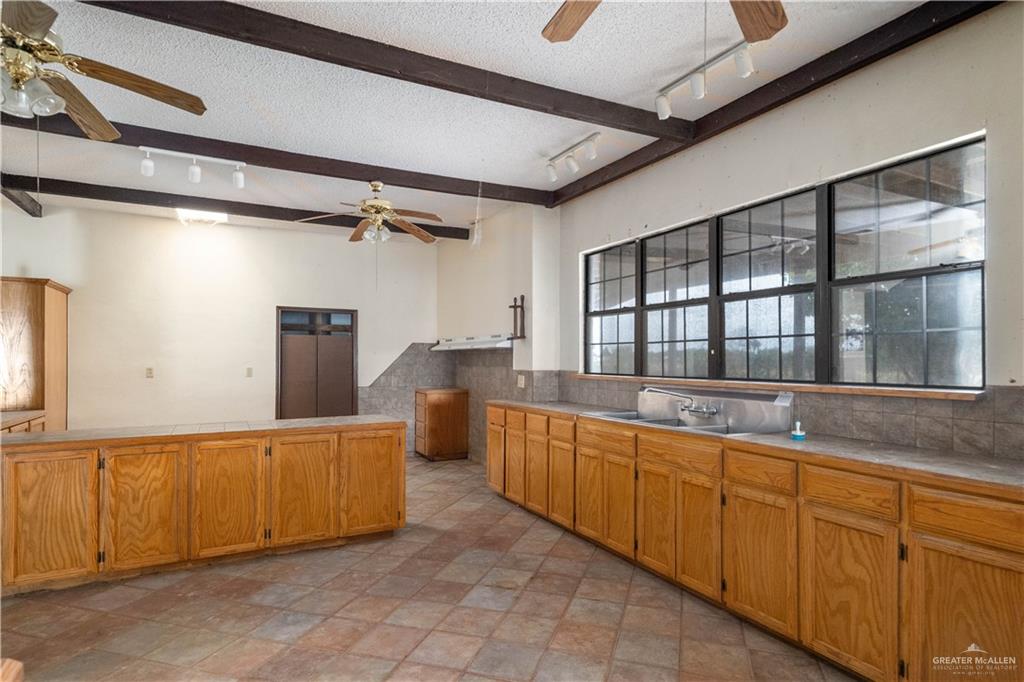 7654 East Alberta Road Edinburg, TX 78542 - Photo 22 of 33 a large kitchen with stainless steel appliances granite countertop a sink and cabinets