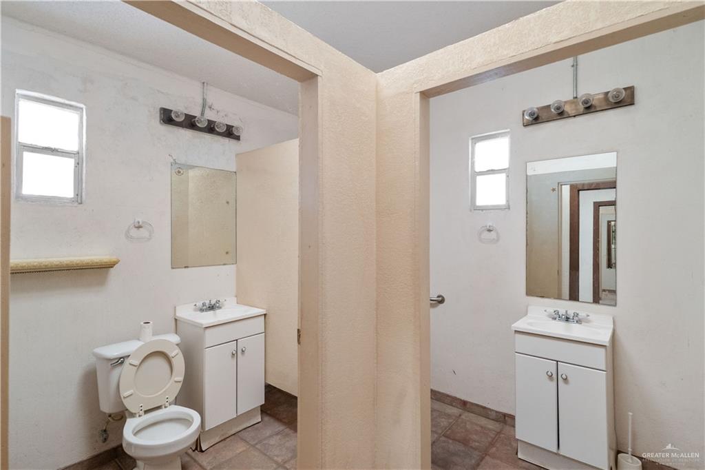 7654 East Alberta Road Edinburg, TX 78542 - Photo 26 of 33 a bathroom with a toilet sink and mirror