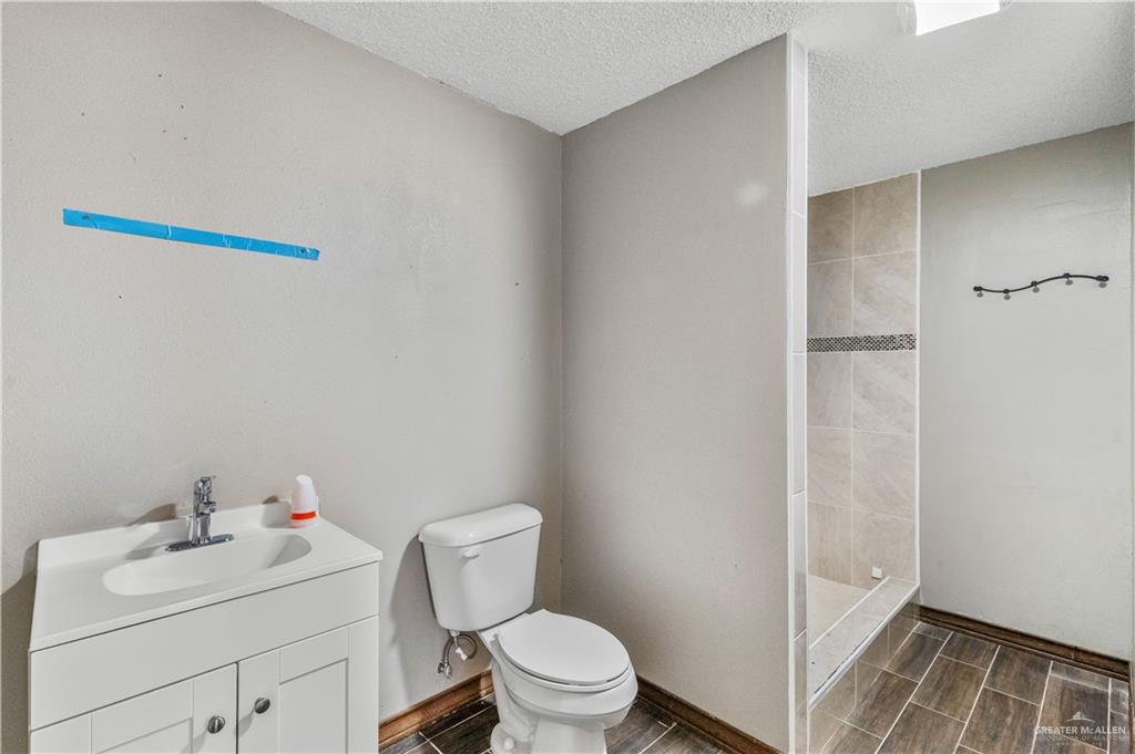 7654 East Alberta Road Edinburg, TX 78542 - Photo 29 of 33 a bathroom with a sink toilet and vanity