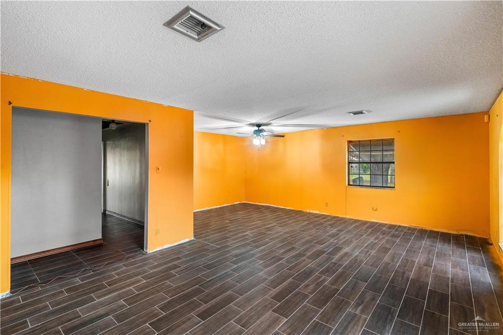 7654 East Alberta Road Edinburg, TX 78542 - Photo 30 of 33 a view of an empty room with wooden floor and a window