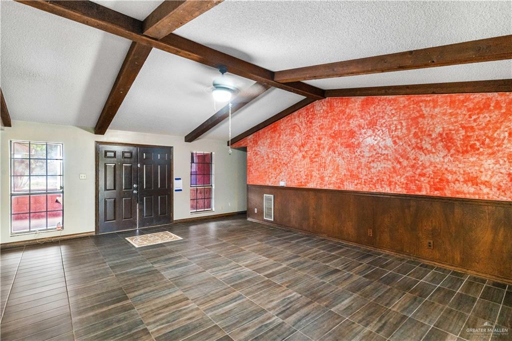 7654 East Alberta Road Edinburg, TX 78542 - Photo 6 of 33 en empty room with wooden floor and windows
