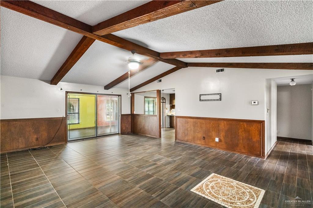 7654 East Alberta Road Edinburg, TX 78542 - Photo 8 of 33 a view of an empty room with wooden floor and a window