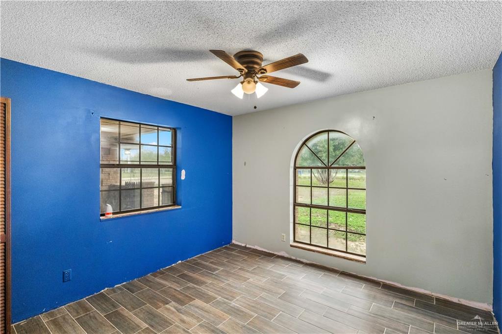 7654 East Alberta Road Edinburg, TX 78542 - Photo 9 of 33 a view of an empty room with window and chandelier fan