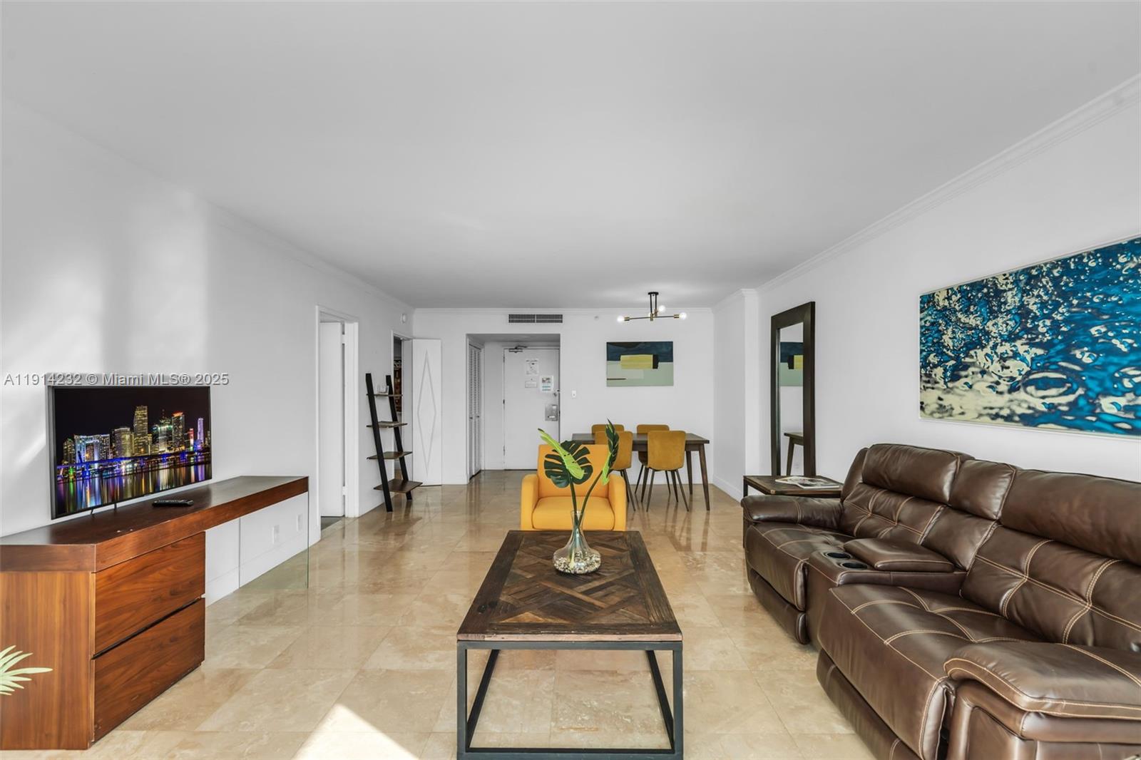 5101 Collins Avenue, Unit 12U Miami Beach, FL 33140 - Photo 3 of 26 a living room with furniture and a flat screen tv
