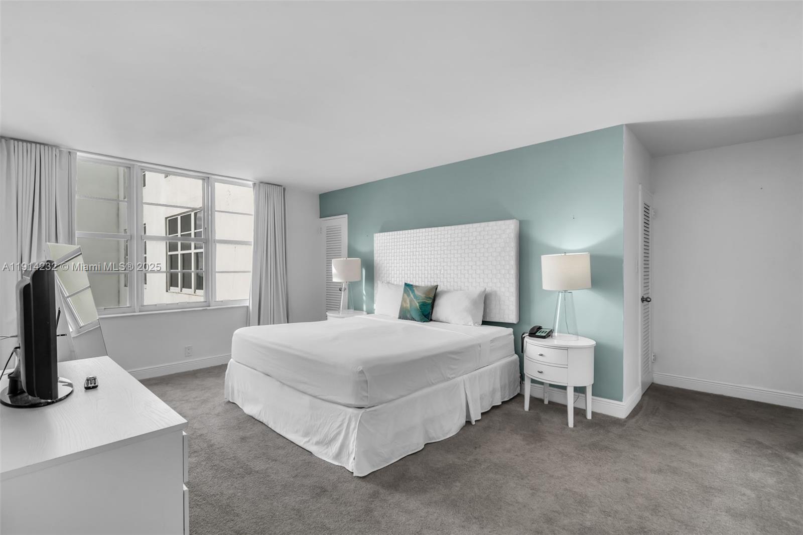 5101 Collins Avenue, Unit 12U Miami Beach, FL 33140 - Photo 6 of 26 a bedroom with a bed and a window