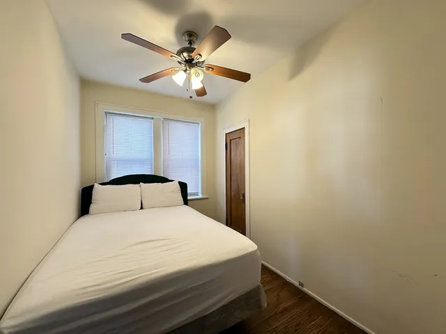 a bedroom with a large bed and a chandelier