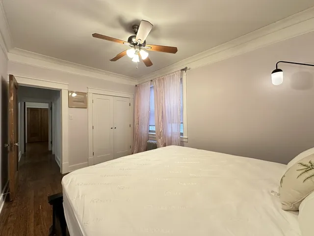 a bedroom with a large bed and closet