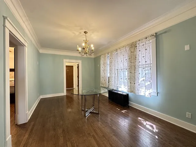 a view of a room with wooden floor and windows