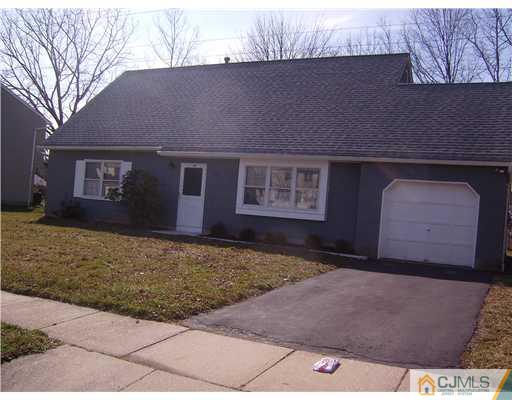 39 Roxy Avenue Edison, NJ 08820 - Photo 2 of 20 a front view of a house with a yard and garage