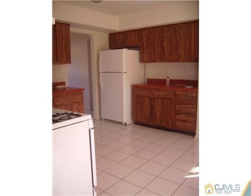 39 Roxy Avenue Edison, NJ 08820 - Photo 5 of 20 a kitchen with a refrigerator and a stove