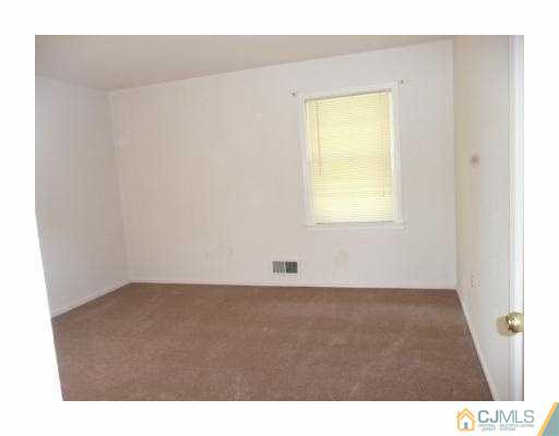 39 Roxy Avenue Edison, NJ 08820 - Photo 7 of 20 a view of an empty room with a window