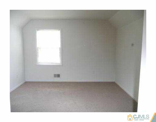 39 Roxy Avenue Edison, NJ 08820 - Photo 9 of 20 a view of an empty room with a window
