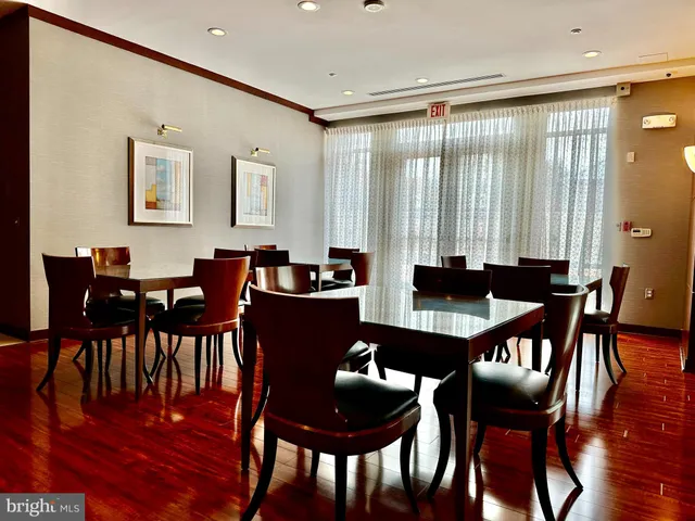 a dining room with furniture and wooden floor