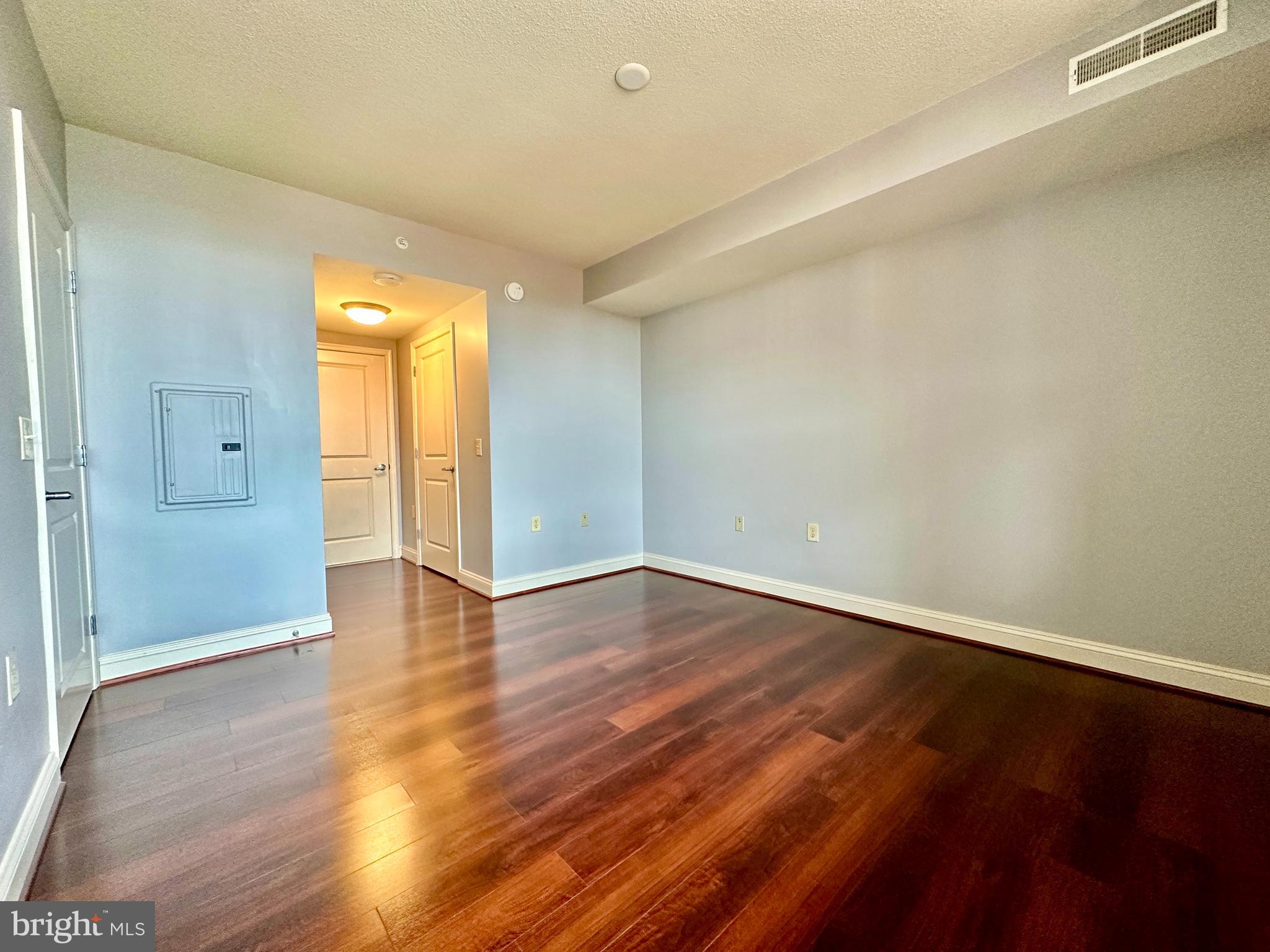 11760 Sunrise Valley Drive, Unit 512 Reston, VA 20191 - Photo 7 of 19 a view of an empty room with wooden floor and a window