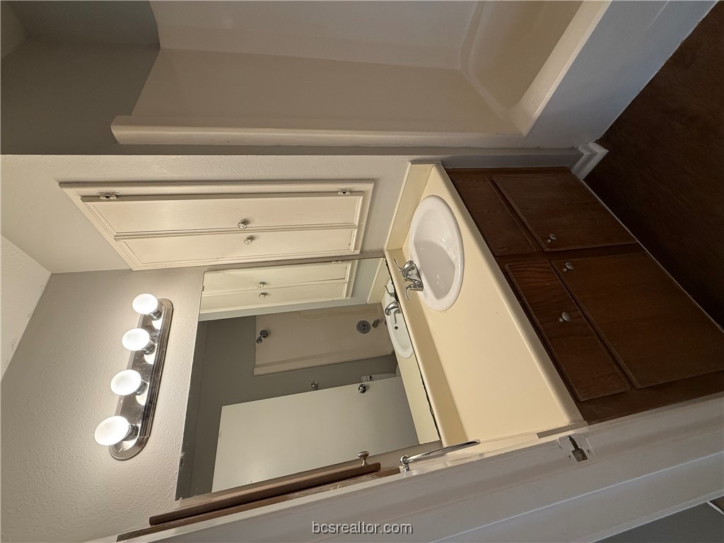 902 Spring Loop, Unit C College Station, TX 77840 - Photo 9 of 11 Full bath with vanity, tub / shower combination, and dark wood finished floors