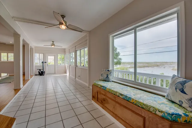 a spacious bedroom with a bed and glass window