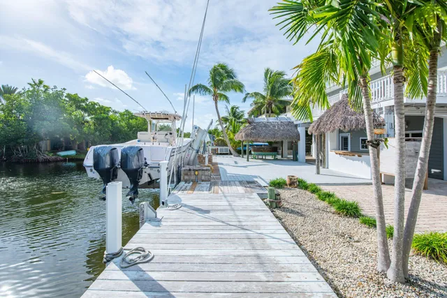 a front view of a house with garden and sitting area