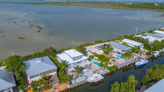 an aerial view of a house with a lake view