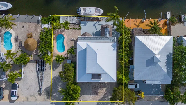 an aerial view of a house with yard