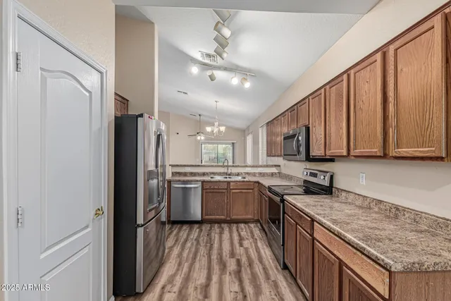 a kitchen with a sink stove and refrigerator
