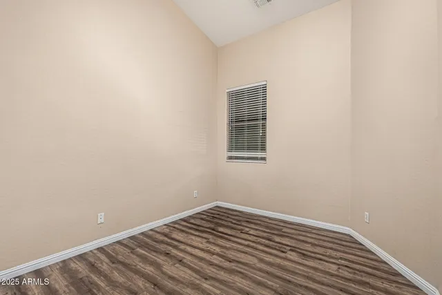a view of a room with wooden floor and a window