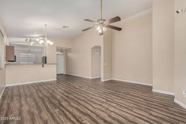 a view of a kitchen with wooden floor and a chandelier