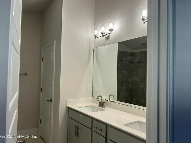 a bathroom with a sink and a mirror
